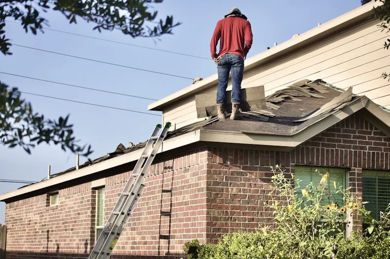 Professional roofer working on a residential roof in Gulf Breeze